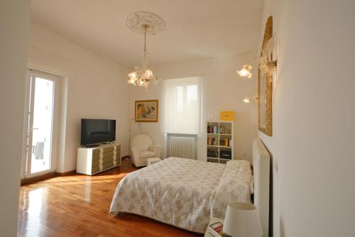 a bedroom with a bed and a flat screen tv at Palazzo Podestà in Civitavecchia