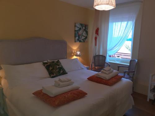 a bedroom with a bed with two towels on it at Chambres d'Hotes CASCAROT in Lechâtelet