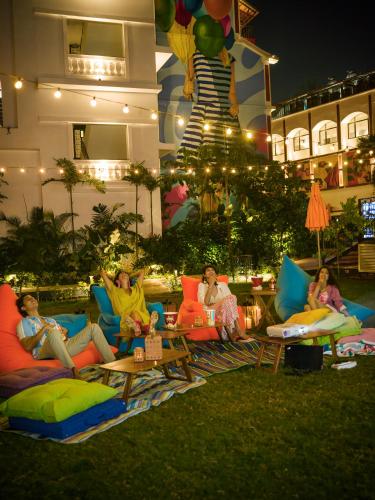 a group of women sitting on couches in the grass at Hyatt Ronil Goa - a JdV by Hyatt Hotel in Calangute