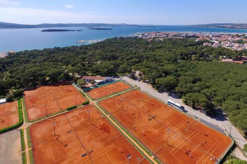 an aerial view of a tennis court next to the water at Ilirija Resort Hotel Ilirija in Biograd na Moru