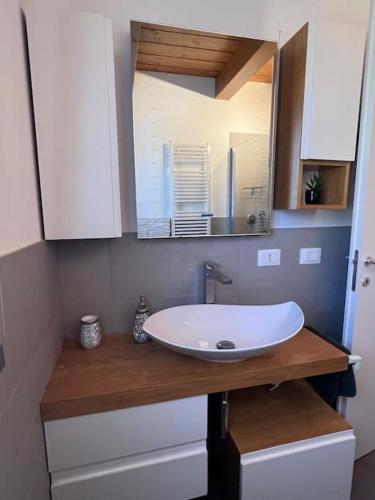 a bathroom with a sink and a mirror on a counter at Giada Family House in Senigallia