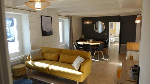 a living room with a couch and a dining room at Paimpol centre 500m du port in Paimpol