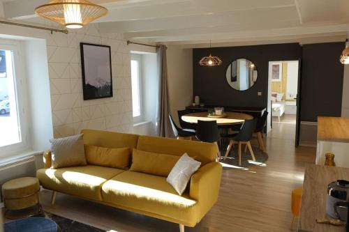 a living room with a couch and a dining room at Paimpol centre 500m du port in Paimpol