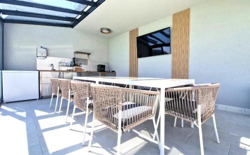 a kitchen with a white table and chairs at X rent apartment in Prim Decembrie