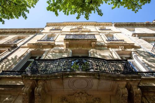 an ornate balcony on the side of a building at Superbes Studios - Place des Quinconces in Bordeaux