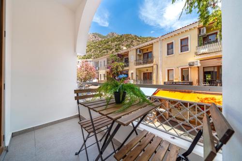 a balcony with two chairs and a table with plants at Melisa Boutique Hotel & Spa in Kas