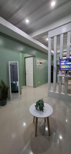 a room with a table with a plant on it at Convill Residences 3 in General Santos