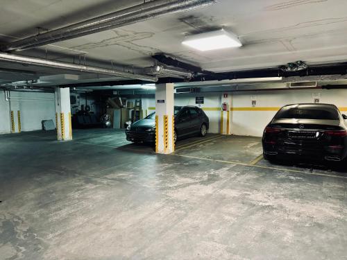 a parking garage with two cars parked in it at Apartament 24 AbsyntApart Rynek Wrocław in Wrocław