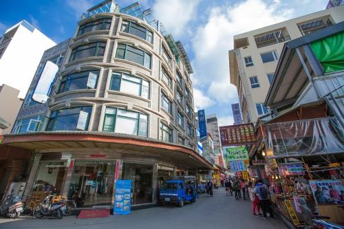 a tall building on a street in a city at Shuian Lakeside Hotel in Yuchi