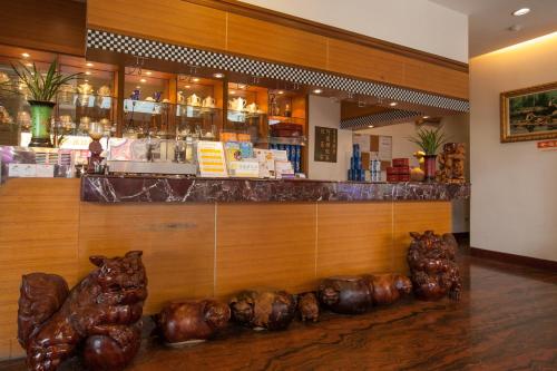 a restaurant with a bar with bear statues in front of it at Shuian Lakeside Hotel in Yuchi