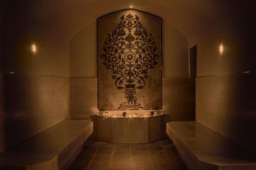 a large stoneolith with a wall in a room at Opera Plaza Hotel Marrakech in Marrakesh