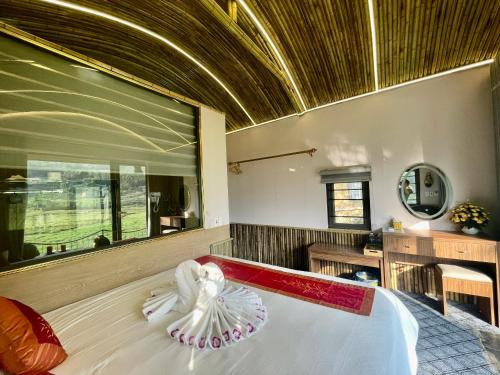 a bedroom with a large bed and a large mirror at Sapa Bamboo Eco in Sa Pa
