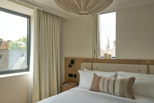 a bedroom with a bed with a large window at The Store in Oxford
