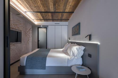 a bedroom with a large bed with a wooden ceiling at Ca' Amae Portovener e in Portovenere