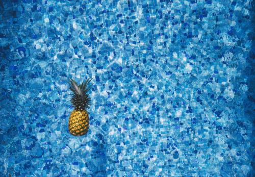 a pineapple sitting in a pool of water at Virtu Suites in Agios Prokopios