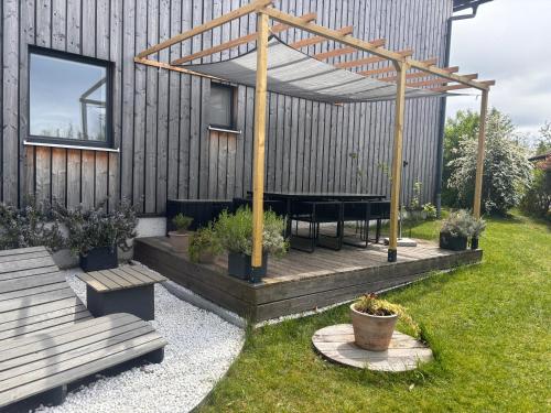 PettingにあるModerne Ferienwohnungen mit Designbadのテーブルと木製のデッキのある裏庭