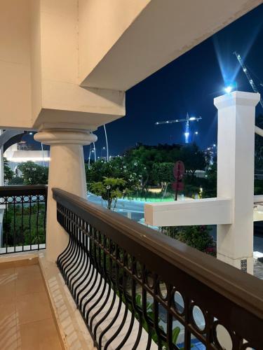 a balcony with a view of a pool at night at Yas Island in Abu Dhabi