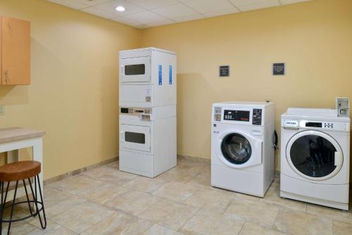a laundry room with two machines and a washer at Hilton Garden Inn Denton in Denton