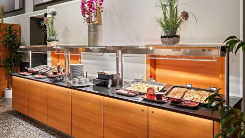 a buffet in a restaurant with food on display at Hilton Dresden an der Frauenkirche in Dresden