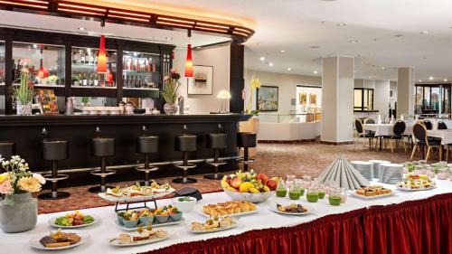 a buffet line with food on a table at Hilton Dresden an der Frauenkirche in Dresden