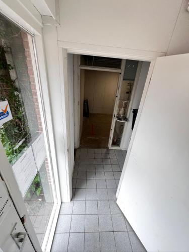 an empty hallway of a building with a door open at B&B Hartje Spakenburg in Spakenburg
