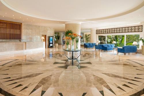 a lobby with a table with flowers on it at Steigenberger Hotel & Nelson Village, Taba in Taba