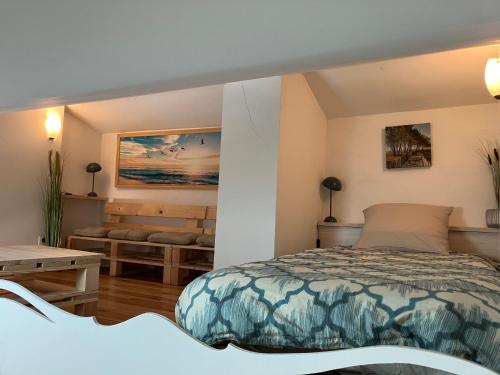a bedroom with a bed and a table at LA HALTE du MONTALIEU in Eysines