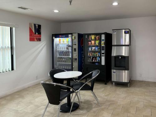a room with two vending machines and a table and chairs at Studio 6 Abilene, TX East in Abilene