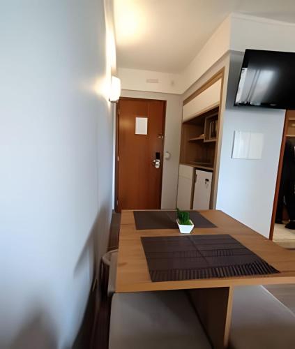 a small kitchen with a wooden table in a room at Flat Live Vila Mariana/Ibirapuera (Apto 1002) in Sao Paulo