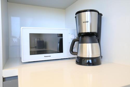a blender sitting on a counter next to a microwave at Serenity Waves Villa 27 in Sophtadhes