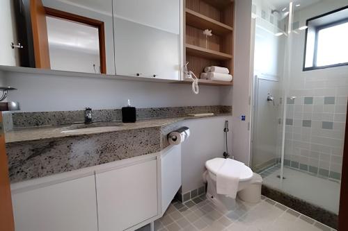 a white bathroom with a sink and a toilet at Flat Live Vila Mariana/Ibirapuera (Apto 1002) in Sao Paulo