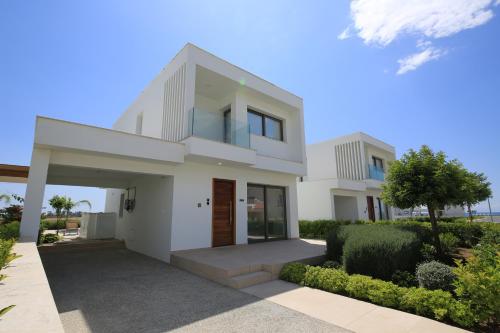 a large white house with a driveway at Serenity Waves Villa 27 in Sophtadhes