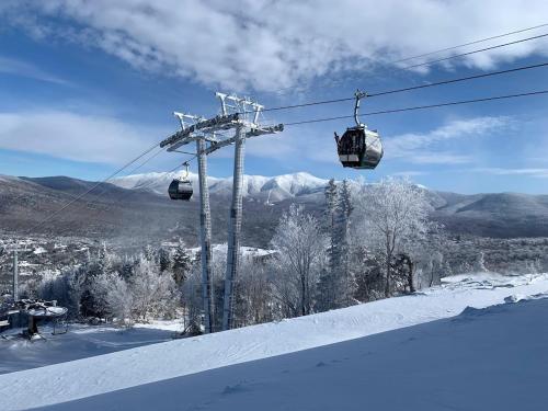 a ski lift in the snow on a mountain at B10 NEW Awesome Tiny Home with AC Mountain Views Minutes to Skiing Hiking Attractions in Carroll