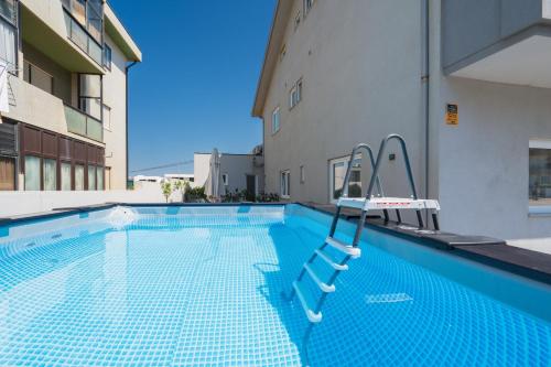 a swimming pool in the middle of a building at Host Wise Arvore in Vila do Conde