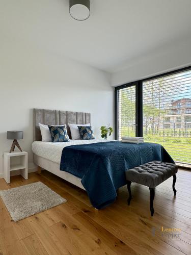 a bedroom with a large bed and a large window at Apartament Krzysztofa Bochusa in Jelenia Góra