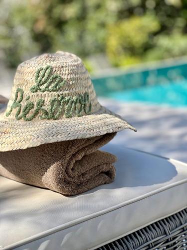 a straw hat sitting on a table with a towel at Mougins Luxury Retreats in Mougins