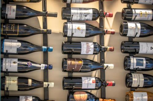 a bunch of wine bottles hanging on a wall at Mougins Luxury Retreats in Mougins