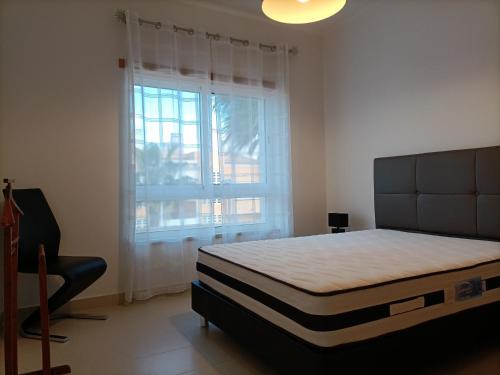 a bedroom with a large bed and a window at Royal Cabanas Golf by Amandio Batista in Cabanas de Tavira