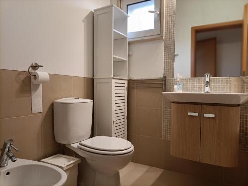 a small bathroom with a toilet and a sink at Royal Cabanas Golf by Amandio Batista in Cabanas de Tavira