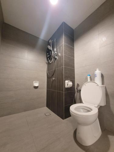 a bathroom with a toilet and a shower at Edumetro Homes in Subang Jaya