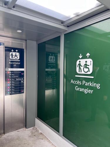 a window of a parking garage with signs on it at Aloft Hotel, By Marriott in Dijon