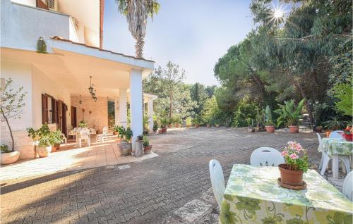 a patio with a table and chairs and a building at Trullo 1474 in Ceglie Messapica