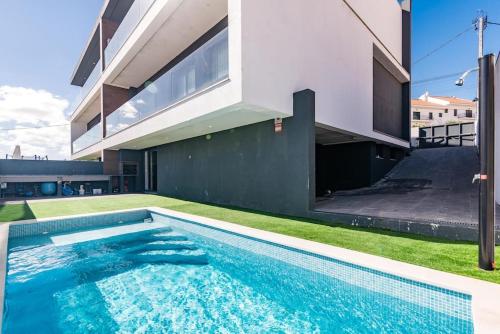 a swimming pool in the backyard of a house at Prime House Lisbon in Famões