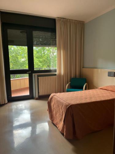 Postel nebo postele na pokoji v ubytování Albergo Casa dell'Ospite