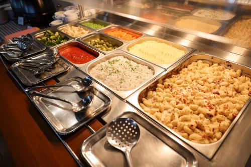 a buffet with many different types of food in trays at Apartments Medena in Trogir