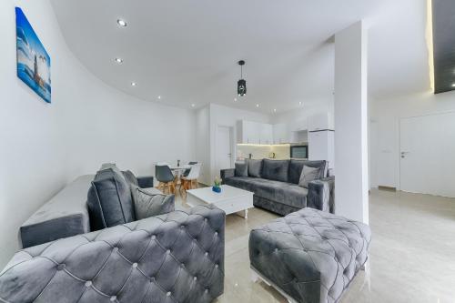 a living room with two couches and a table at Lux DAM Apartments in Bar