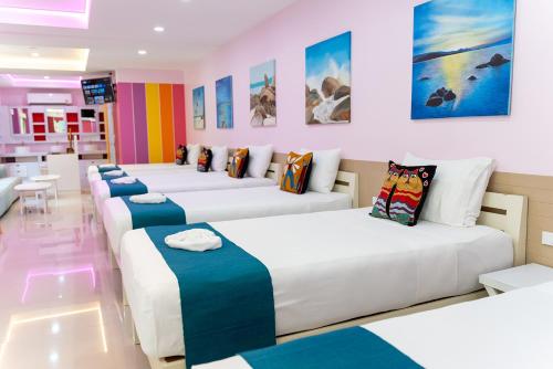 a room with a row of beds in it at LOVE beach club Koh Samui in Chaweng