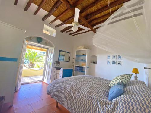 a bedroom with a bed with a wooden ceiling at Casa Scirocco Lipari in Lipari