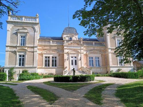 an old mansion with a tree in front of it at Villa Paignon in Montbron