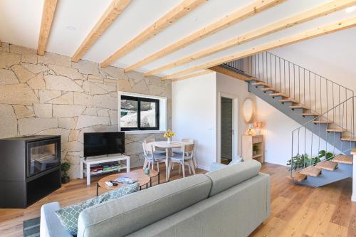 a living room with a couch and a table at Casas das Olas in Arcos de Valdevez